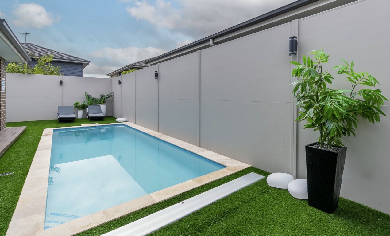 One-time deep pool cleaning service showing pristine pool in modern backyard