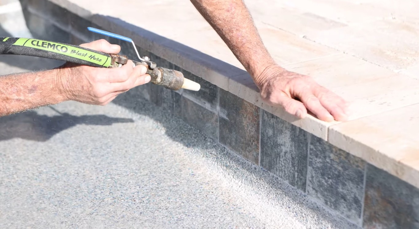 Pool tile cleaning and calcium scale removal showing professional cleaning technique